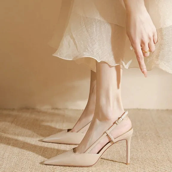 Women's apricot high-heeled sandals with a buckle on the toe strap and thin belts.