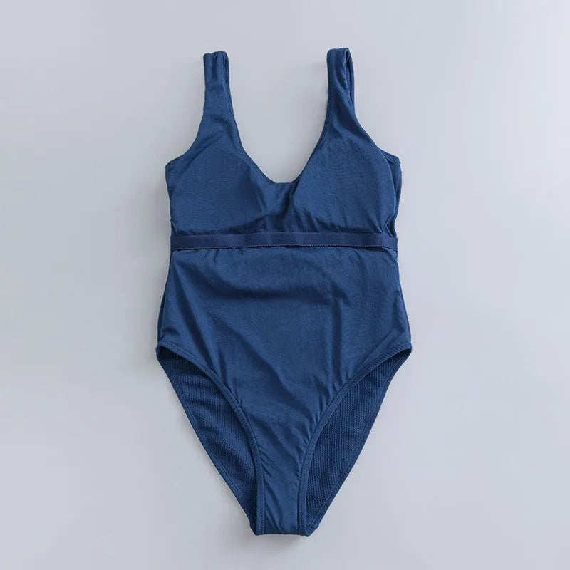 Navy blue women's slim-fit one-piece swimsuit with triangle top and removable padding.