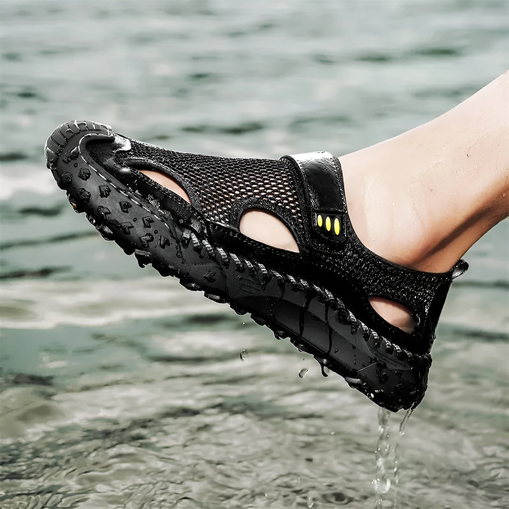 Men's black casual sandals showing breathable mesh upper and Velcro strap closure.