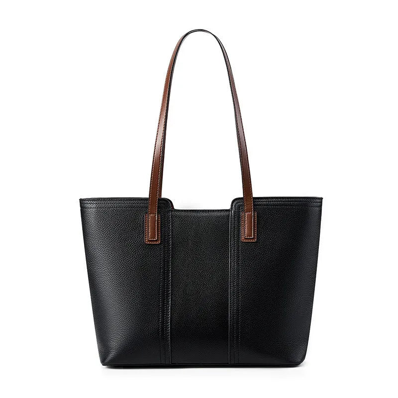 Women's black genuine leather crossbody bag showing horizontal square shape and internal organiser pockets