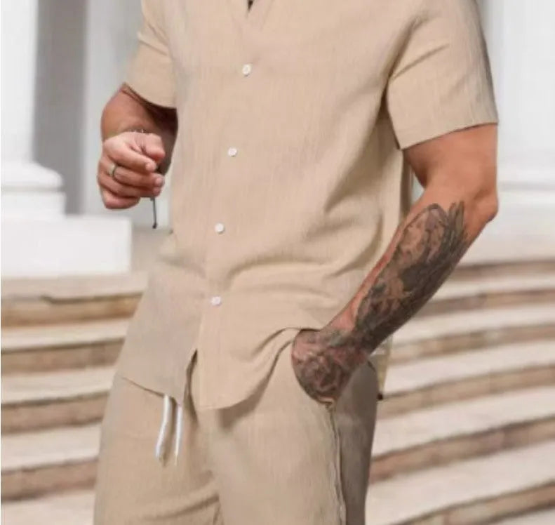 A man wearing a striped short-sleeve shirt and matching shorts from a casual suit set.