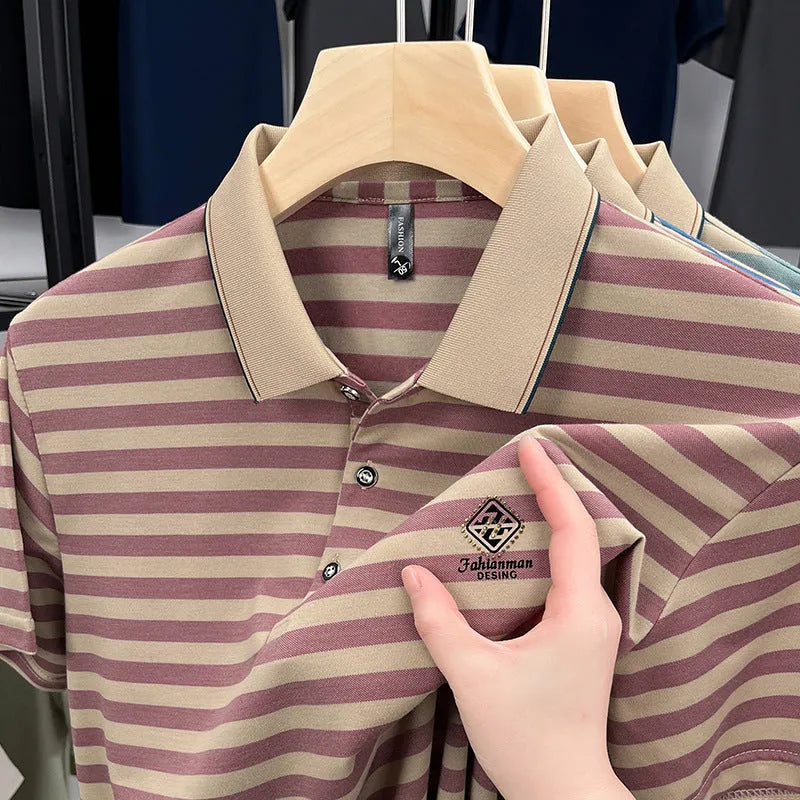 A man wearing a red striped casual t-shirt with a mosaic pattern detail on the chest.
