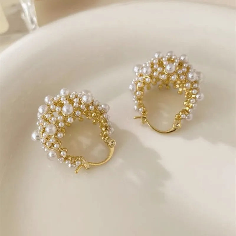 Gold-tone women's earrings with flower basket design and small bead inlay detail