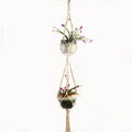 Woven cotton rope plant holder in a rustic style for hanging or tabletop use.