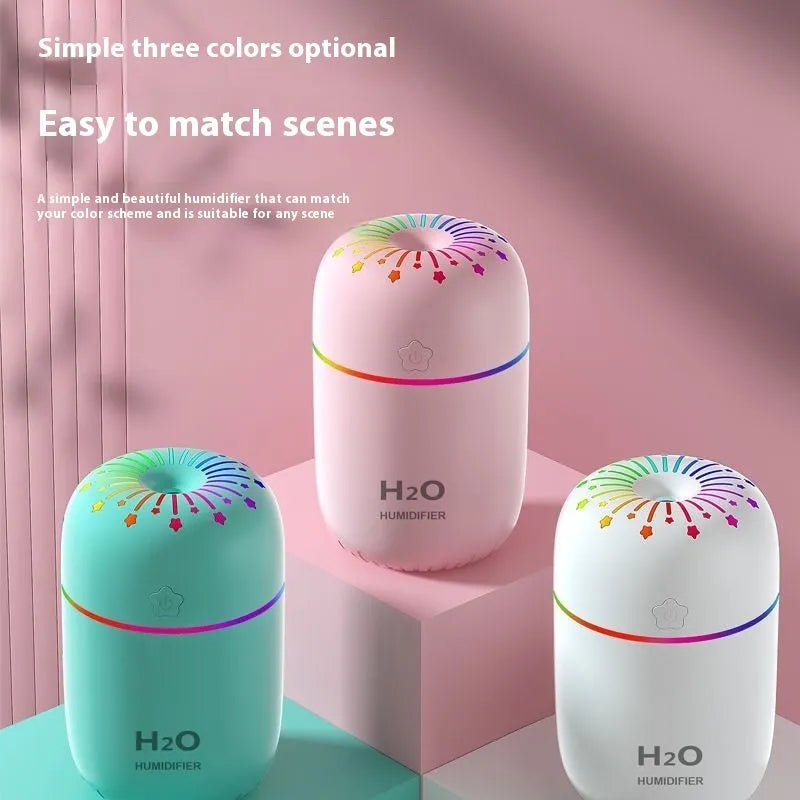 Small white USB portable humidifier with fireworks design on a wooden desk