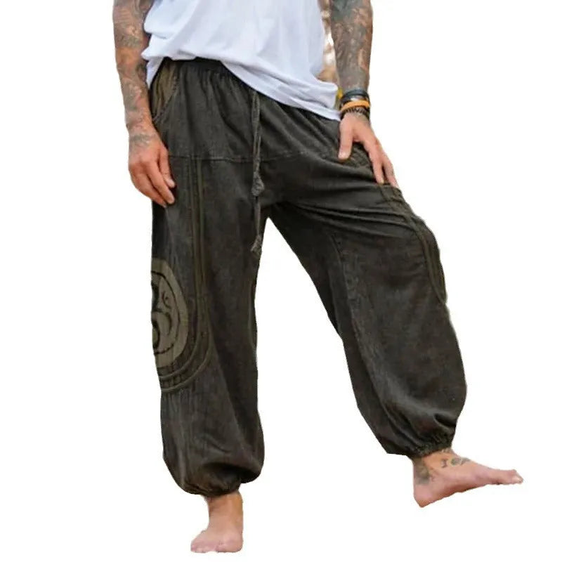 Dark green men's trousers with ethnic pattern and ankle-tied detail on polyester fabric