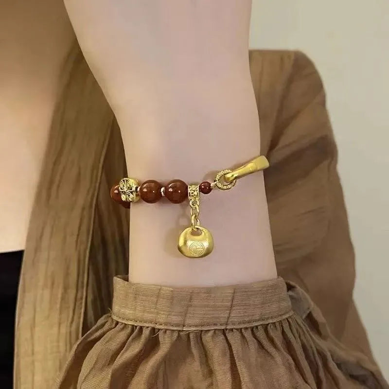 Golden south red agate character ingot bracelet with lucky bag charm design for women