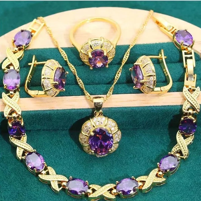 Gold plated zircon jewellery set showing necklace, earrings, ring, and bracelet with coloured cubic zirconia stones.