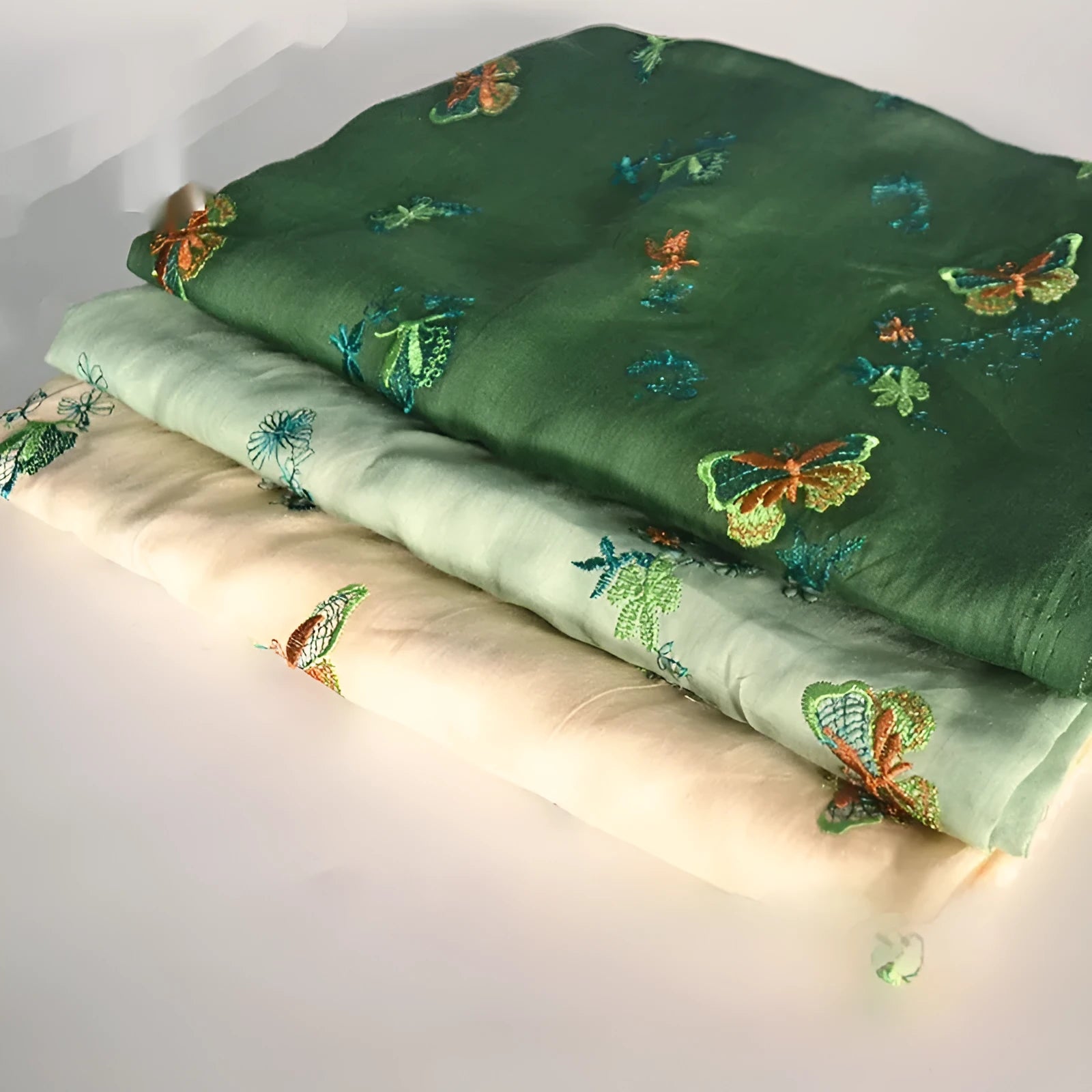 Pure ramie fabric in beige, grass green, and dark green colours, shown with a 1 metre length.