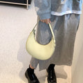Women's retro dumpling-shaped shoulder bag in PU leather showing internal zipper pocket.