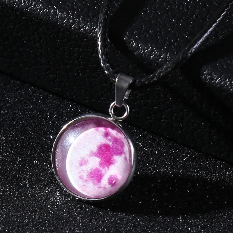 Luminous moon and constellation glass pendant on a silver alloy necklace chain with an extension piece.