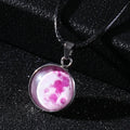 Luminous moon and constellation glass pendant on a silver alloy necklace chain with an extension piece.