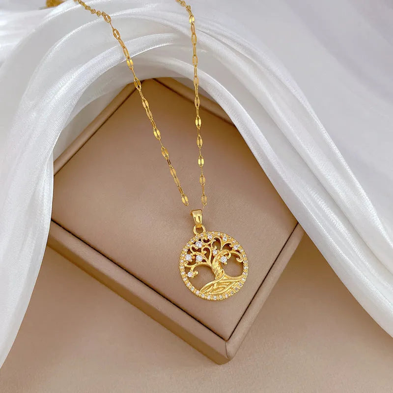 Gold-plated adjustable necklace with a detailed rhinestone and mother-of-pearl lucky tree light pendant.