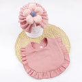 Newborn baby hat and bib set in organic cotton muslin with frilly lace trim