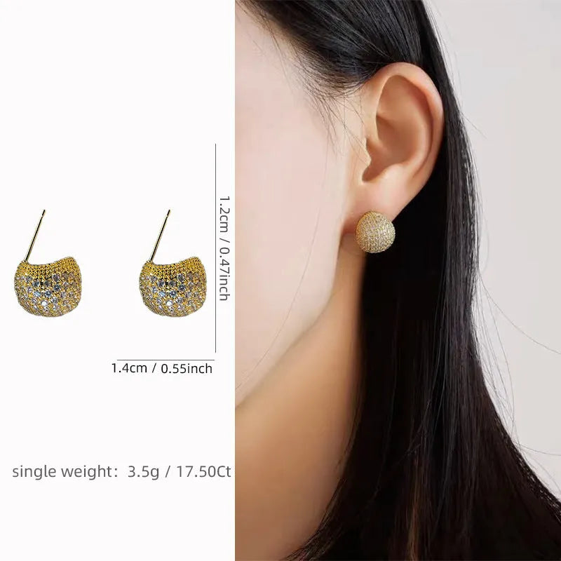Geometric drop-shaped earrings with golden beans ear clip design in gold and white colours