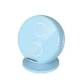 A black multifunctional wireless charging phone holder with integrated Bluetooth speaker on a desk.