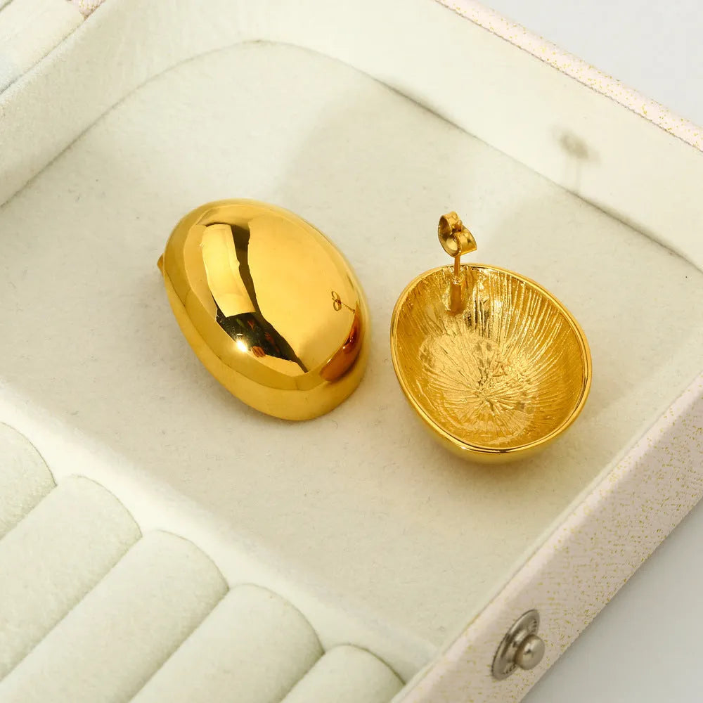 Geometric women's ear studs with a glazed gold electroplated finish and line detailing.