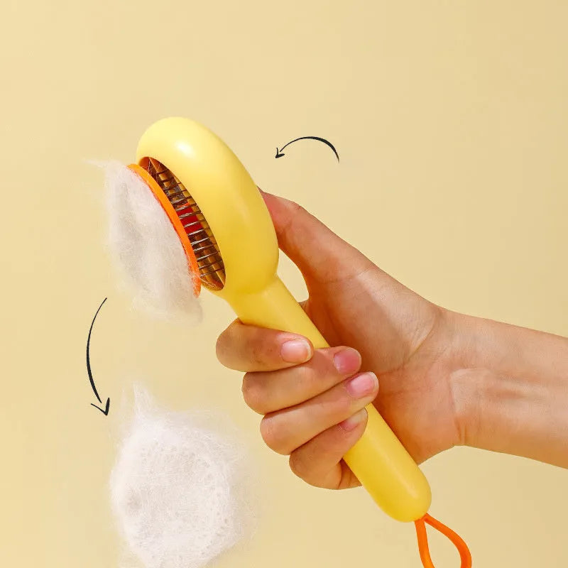 Small yellow duck-shaped pet grooming comb with needle pins for cats and dogs