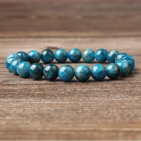 Natural blue apatite elastic beaded bracelet with polished round beads, unisex design, shown on a neutral background