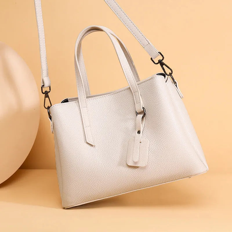Women's cowhide leather shoulder handbag in horizontal square design with internal compartments