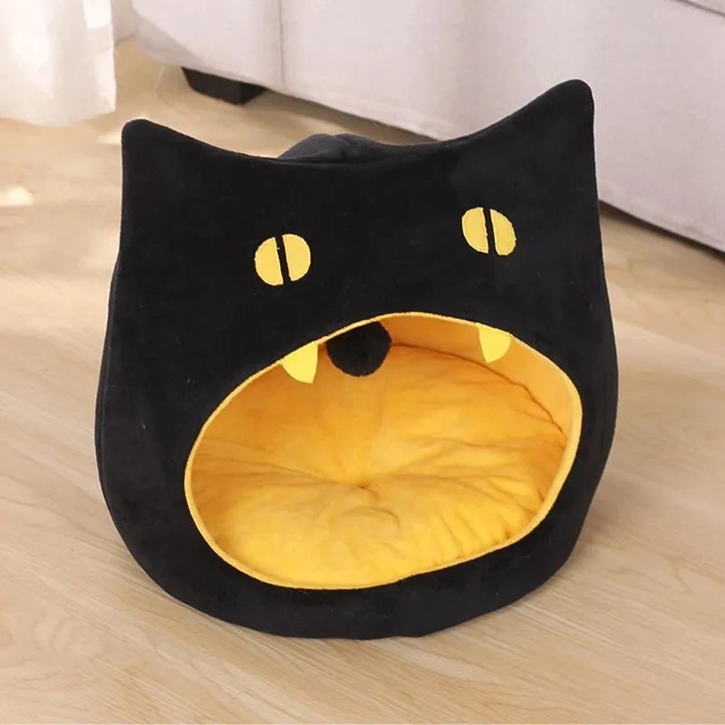 Enclosed cat-shaped pet bed with plush fabric and covered cave design