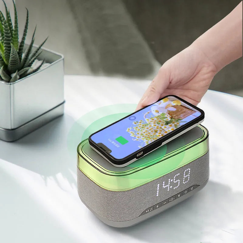 White alarm clock with wireless charging surface and Bluetooth speaker functionality for bedside use