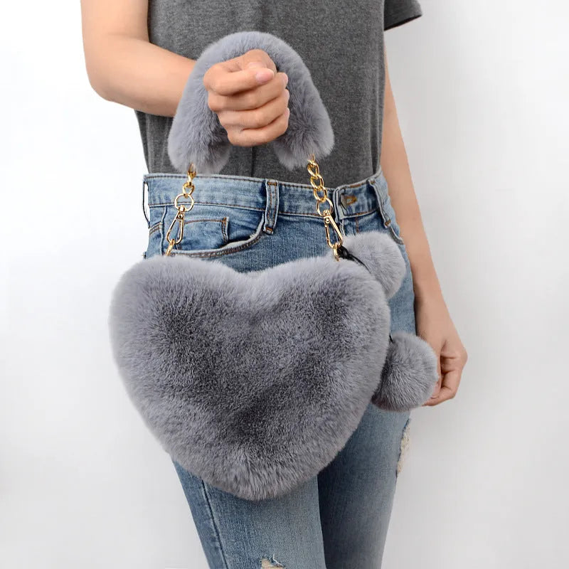 Women's soft plush heart-shaped handbag in medium size with adjustable shoulder strap