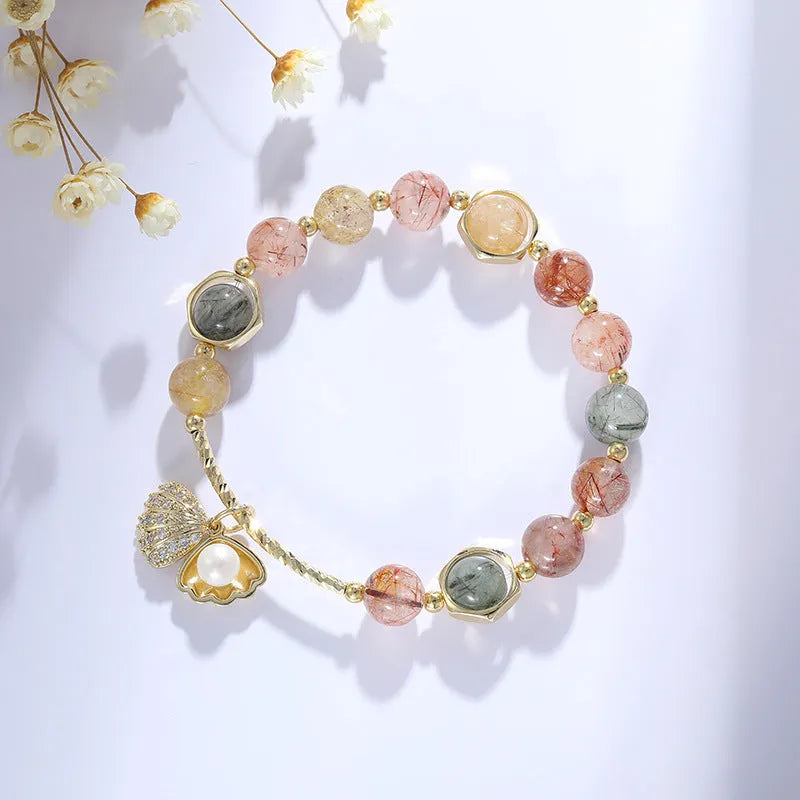 Women's crystal bracelet with coloured hair crystal shells and red sealant flower shells on wrist