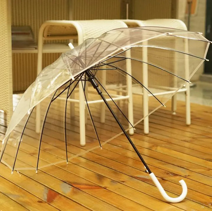 Clear long-handled transparent umbrella with a black curved handle and 16-rib frame on a white background.