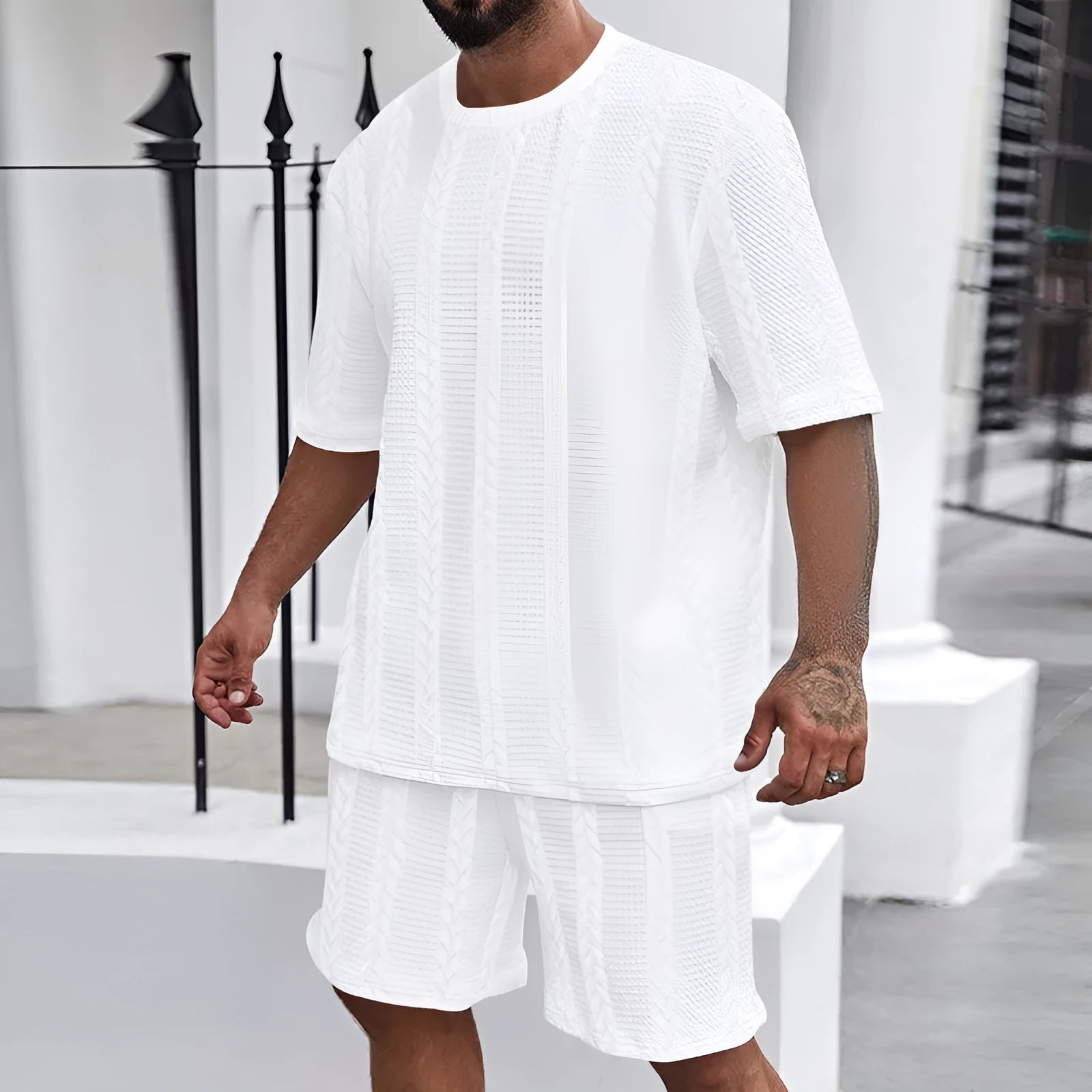 Men's knitted jacquard short sleeve pullover and shorts set in a solid colour on a hanger.