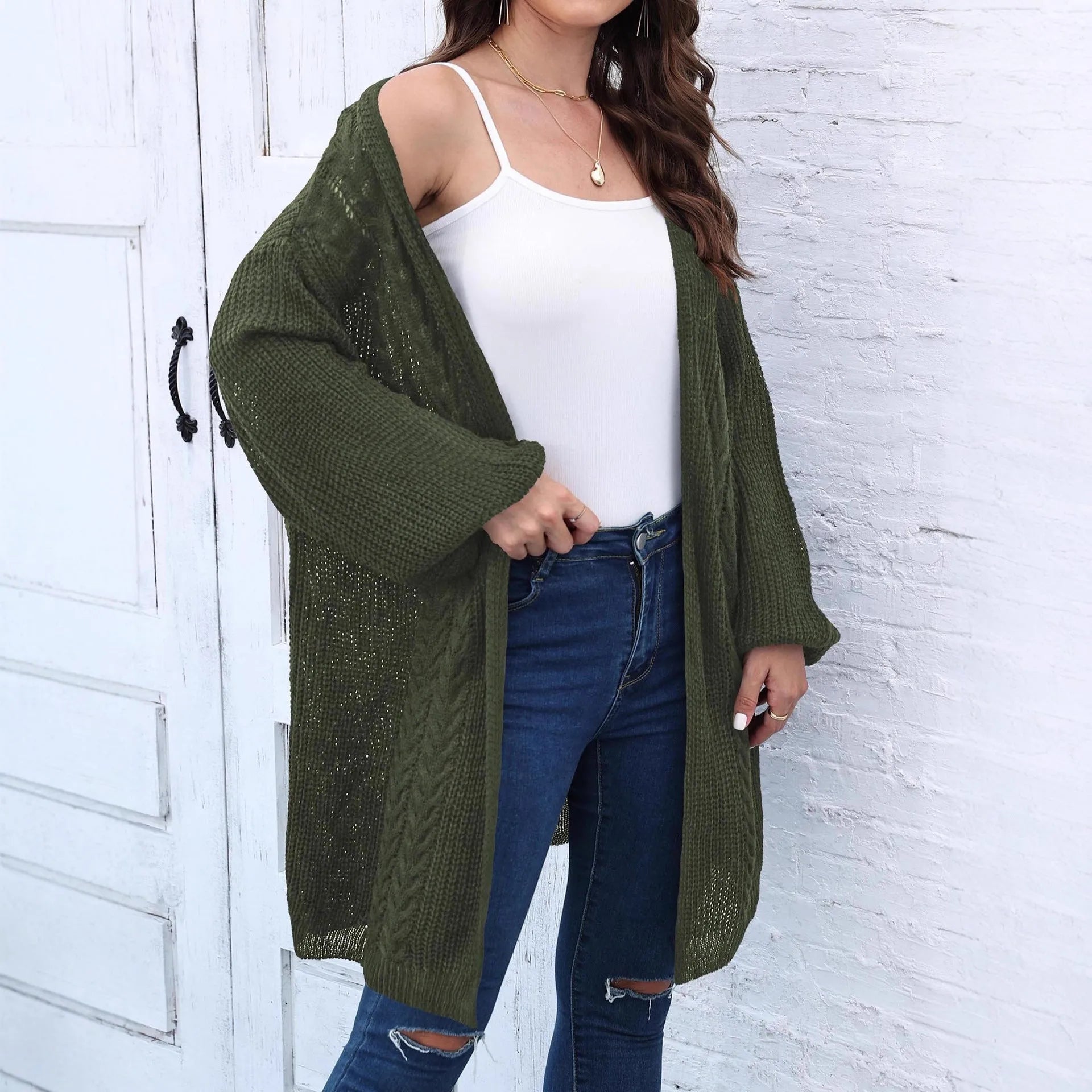 Women's loose-fit acrylic sweater coat in a solid colour, shown in light grey.