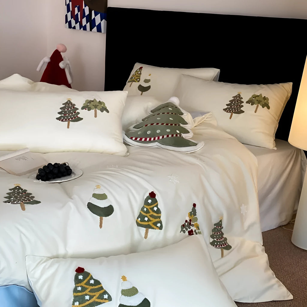 Pure cotton Christmas tree towel embroidery bedding four-piece set in cream blue on a bed.