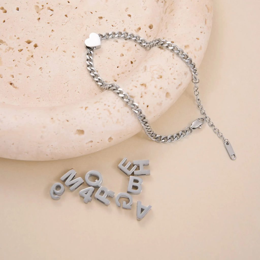 Gold electroplated titanium steel necklace with a single letter A pendant on a 40.5cm blade chain.
