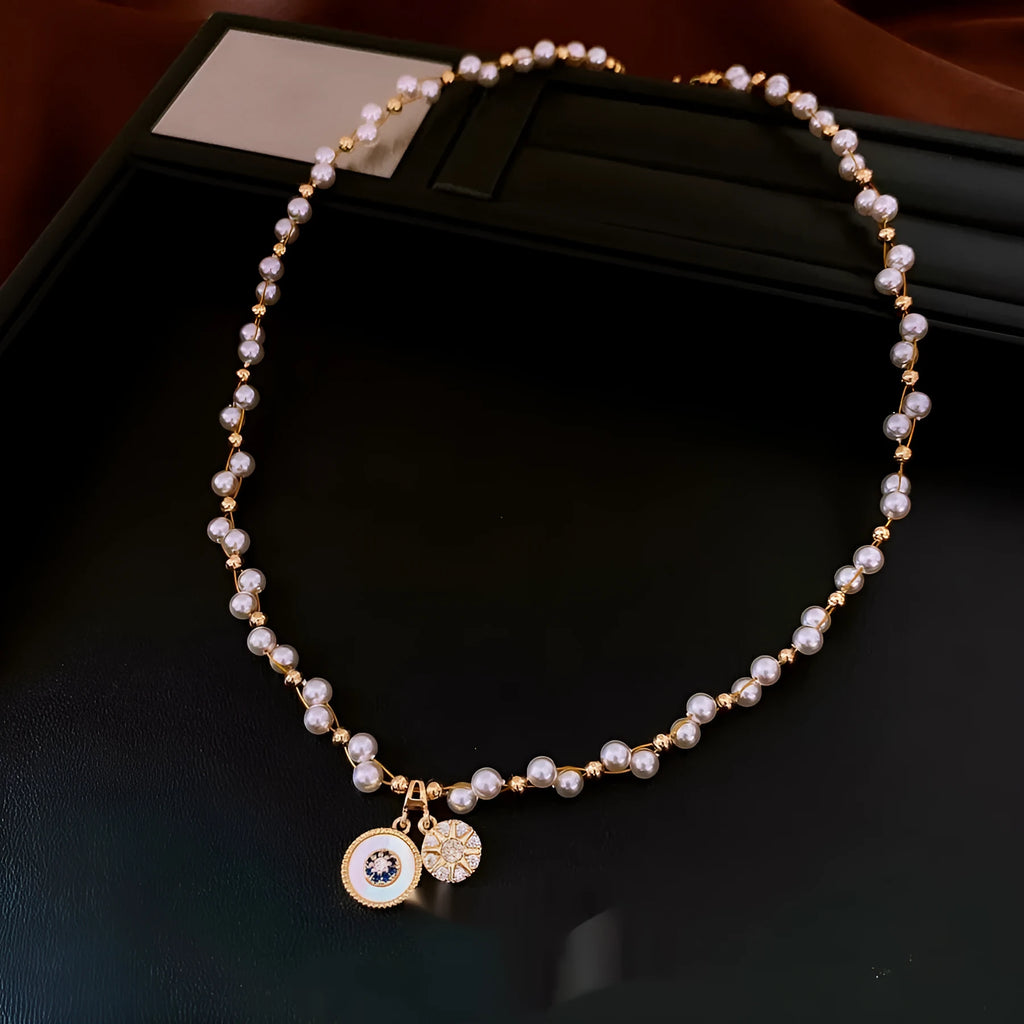 Gold electroplated women's clavicle necklace with round zircon pearl pendant on white background