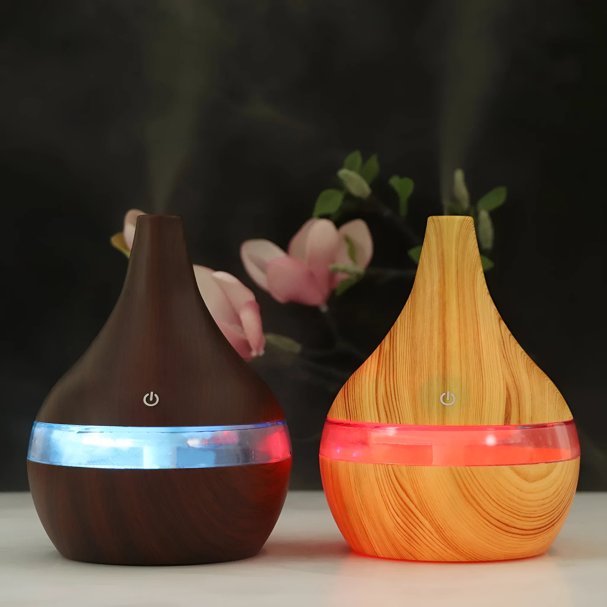 A columnar USB air humidifier with a wood grain finish, remote control, and USB cable on a desktop.