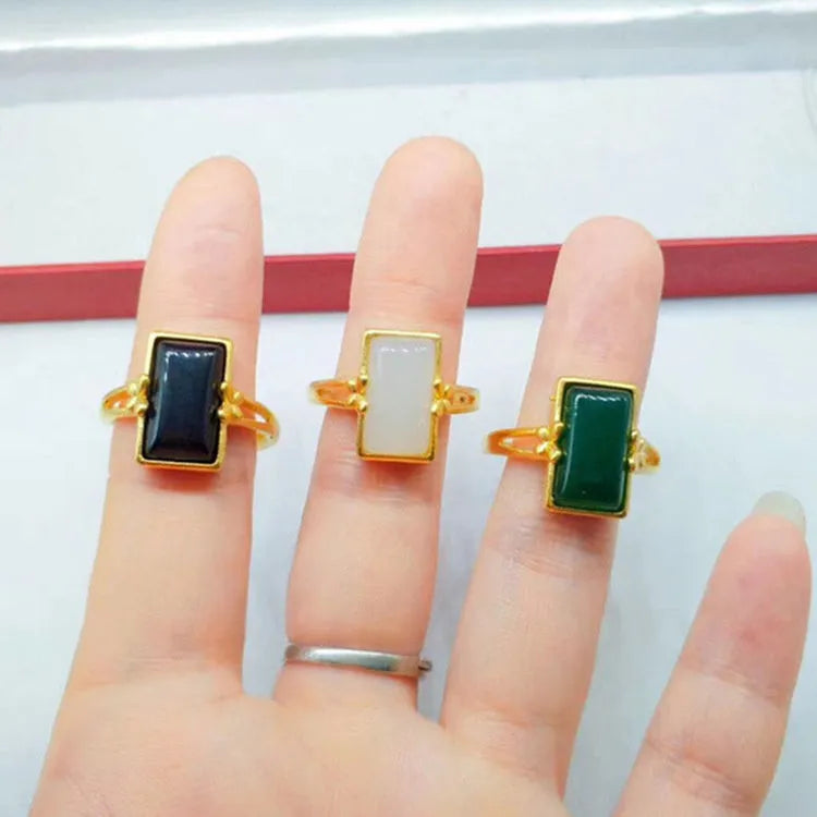 Adjustable brass gold-plated ring with a long green gemstone in a national style setting.