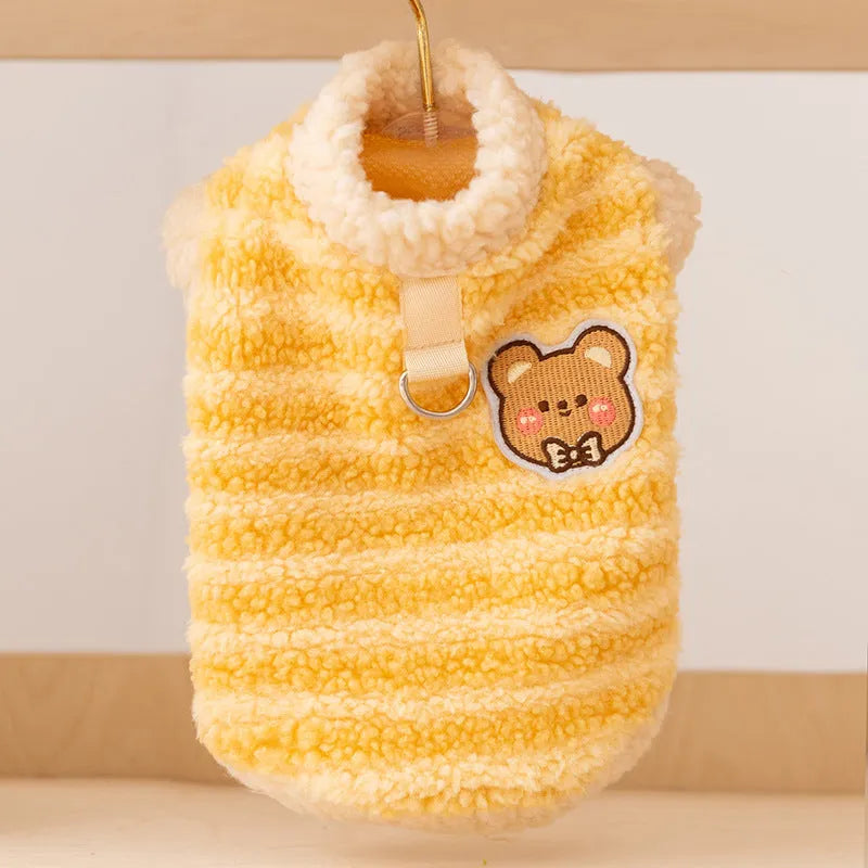 Blue striped lambskin fleece dog coat with drawstring and leash ring on a small dog against a neutral background
