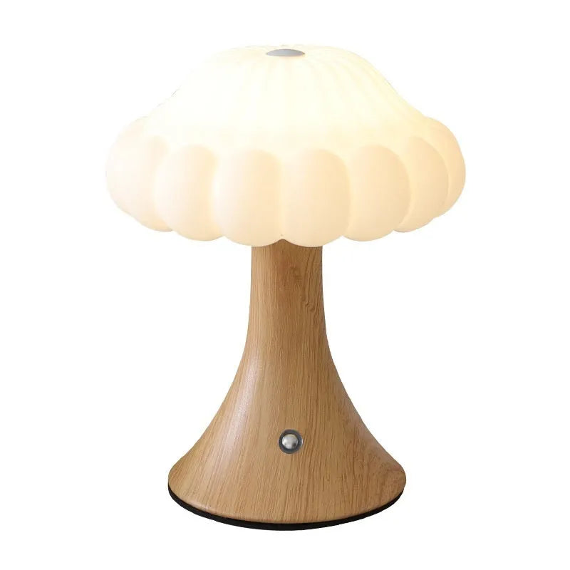 Small mushroom-shaped rechargeable night light in wood grain colour with touch control on desk.