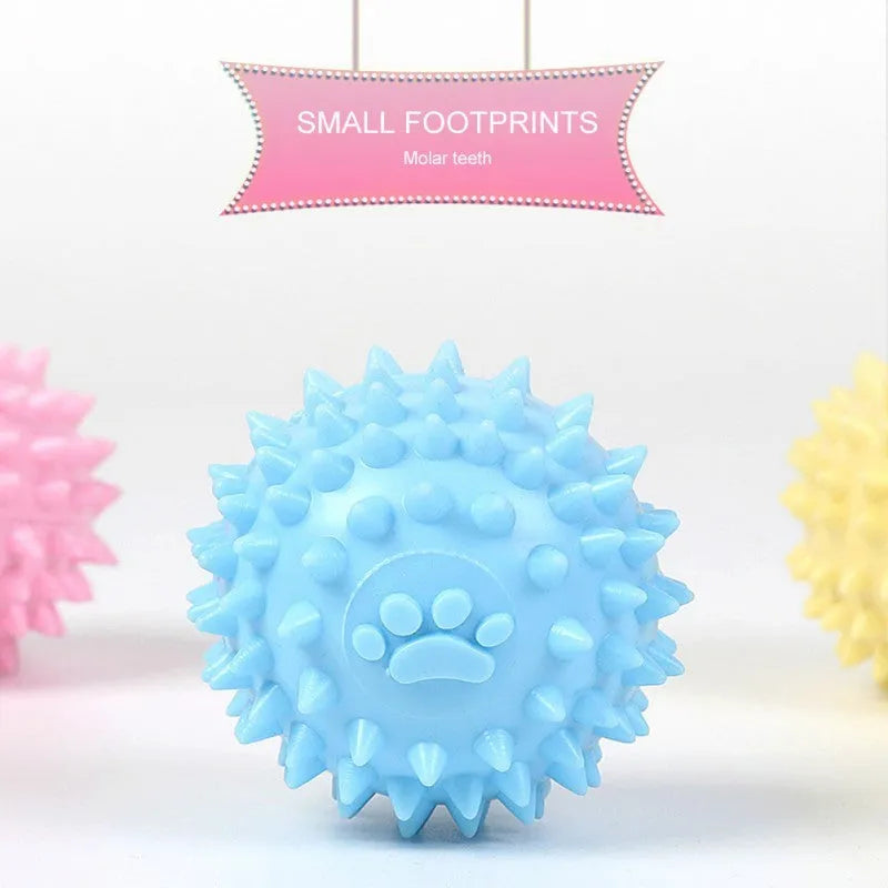 Blue TPR dog chew ball with textured footprint pattern and tooth cleaning nubs