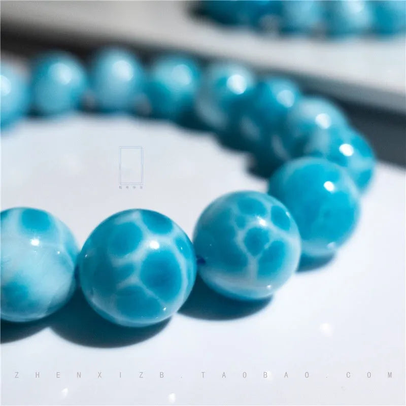 Blue Maillard style bodhi bracelet with natural crystal, sea-pattern stone, and pearls on a white background.
