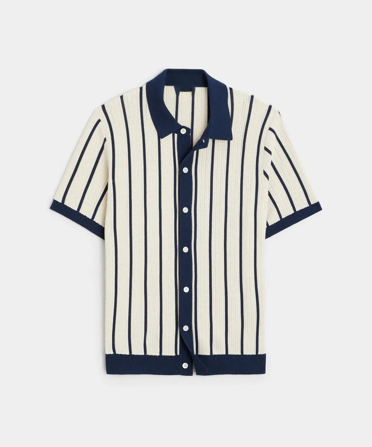 Man wearing a white asymmetric lapel knitted polo shirt with a striped pattern.