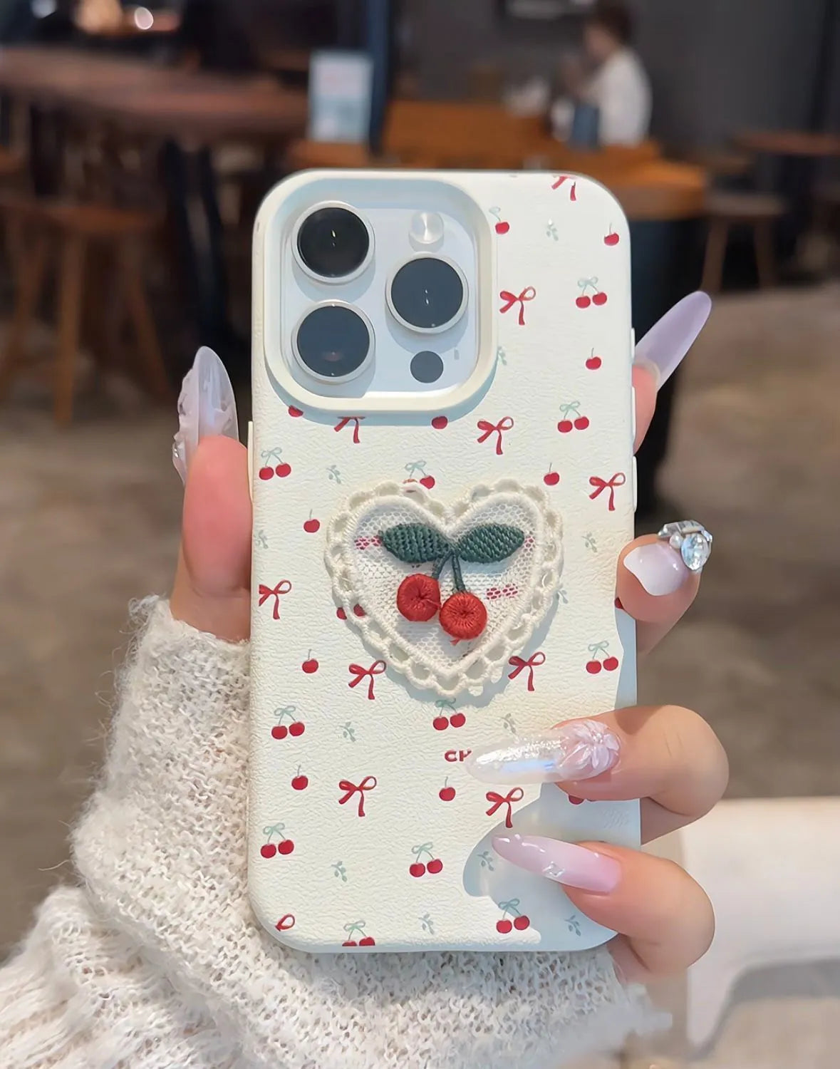 Cherry embroidered silicone iPhone case in litchi pattern white with three-dimensional raised embroidery design