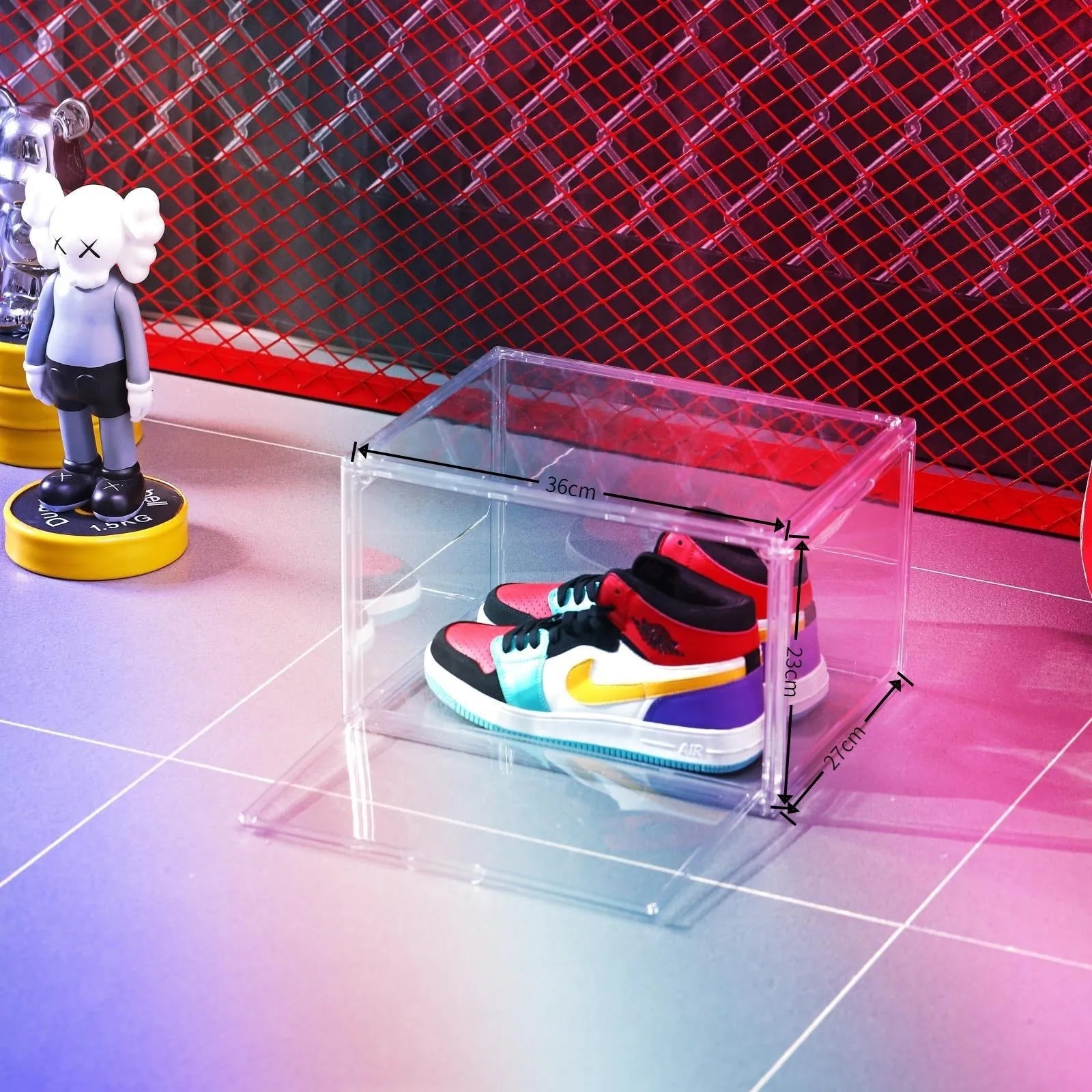 Clear acrylic shoe storage box with magnetic side door open, showing shoes inside.