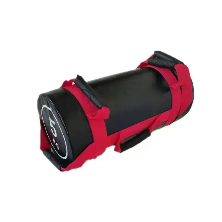 A flat white PVC power lifting sandbag for weight training on a gym floor.