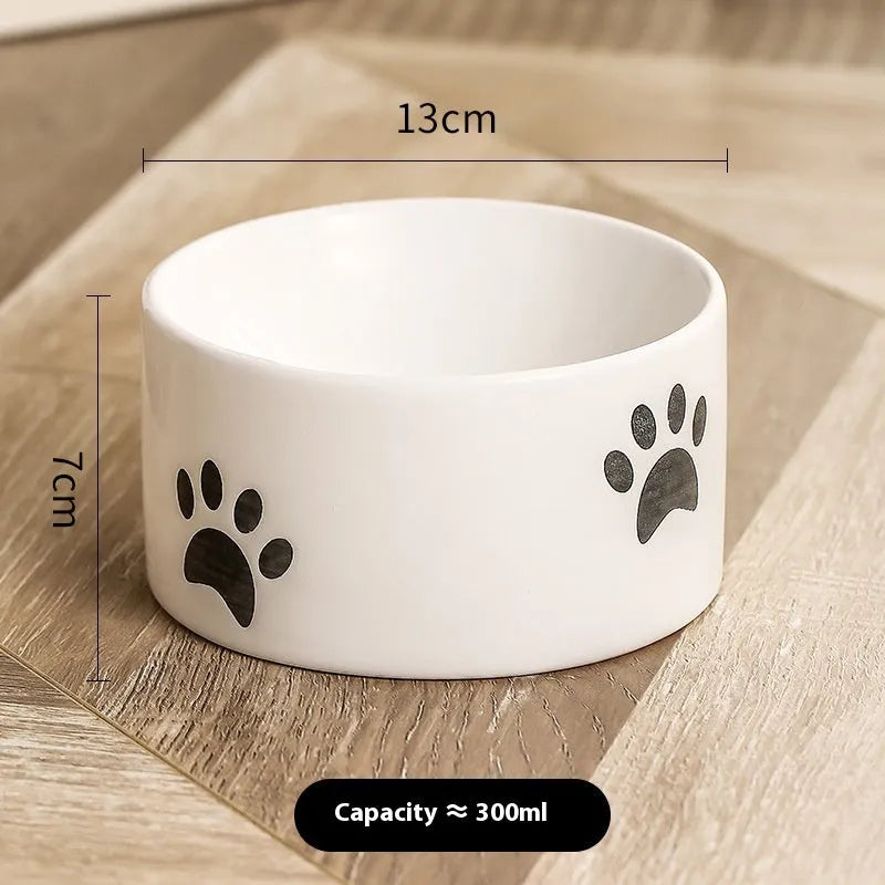 Ceramic cat bowl with high foot design and oblique mouth in cat's paw pattern