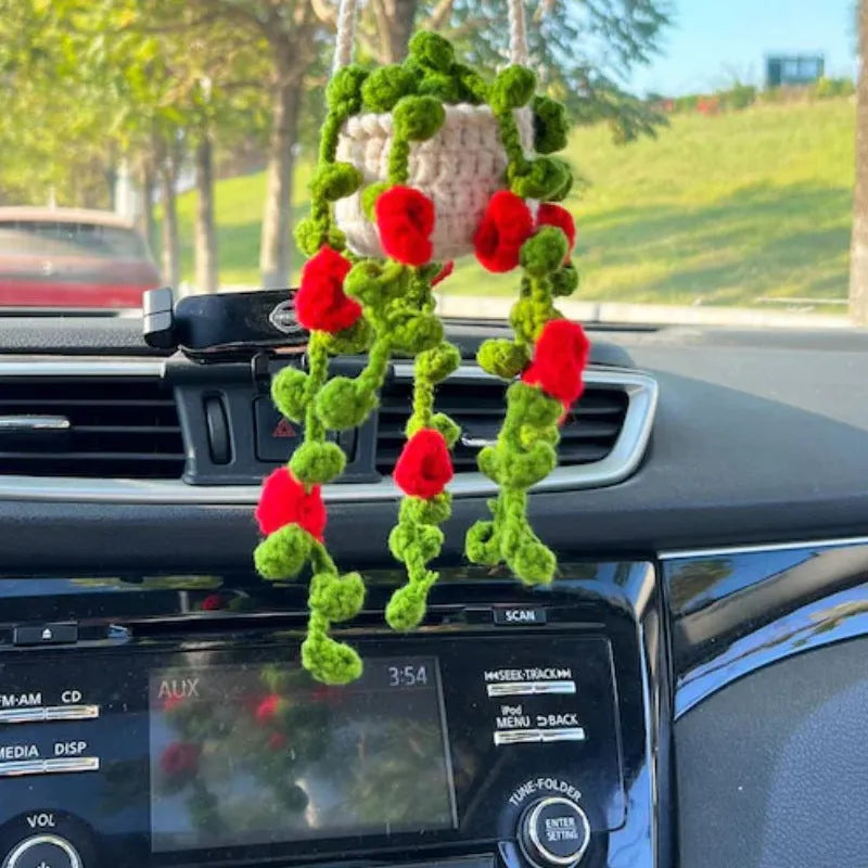 Green and white knitted wool car plant decoration with 8cm base and hanging rope.