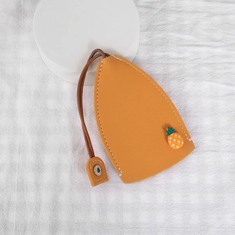 Cartoon pull-out key case in PU leather measuring 14 x 7.5 cm with colourful designs