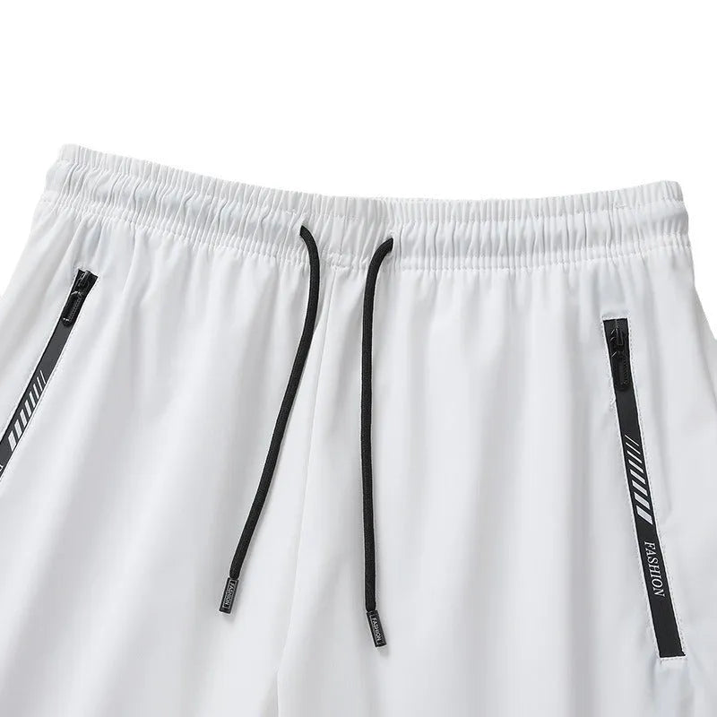 Man wearing black loose-fit quick-dry nylon sports shorts.
