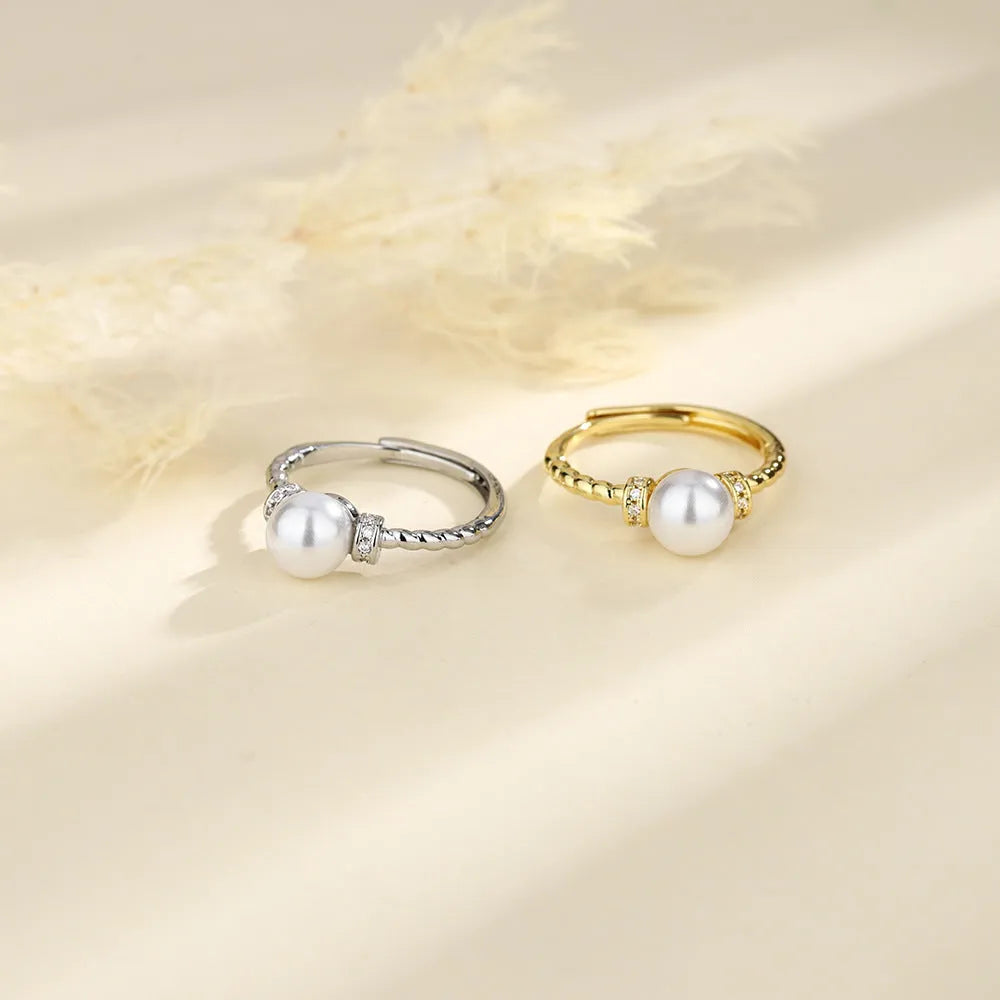 Adjustable antique twist copper ring with a geometric pearl centre in gold and silver colours.