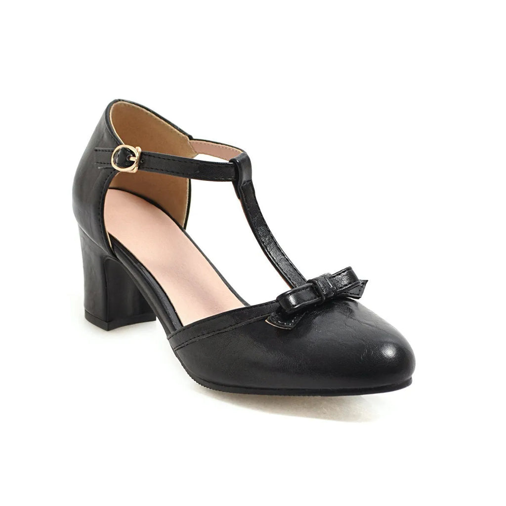 Yellow women's chunky heel sandals with a buckle strap and bow detail on a solid colour PU upper.